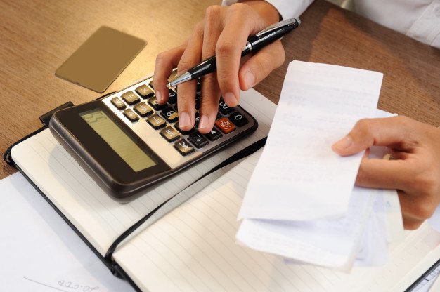 closeup-person-holding-bills-calculating-them_1262-14861